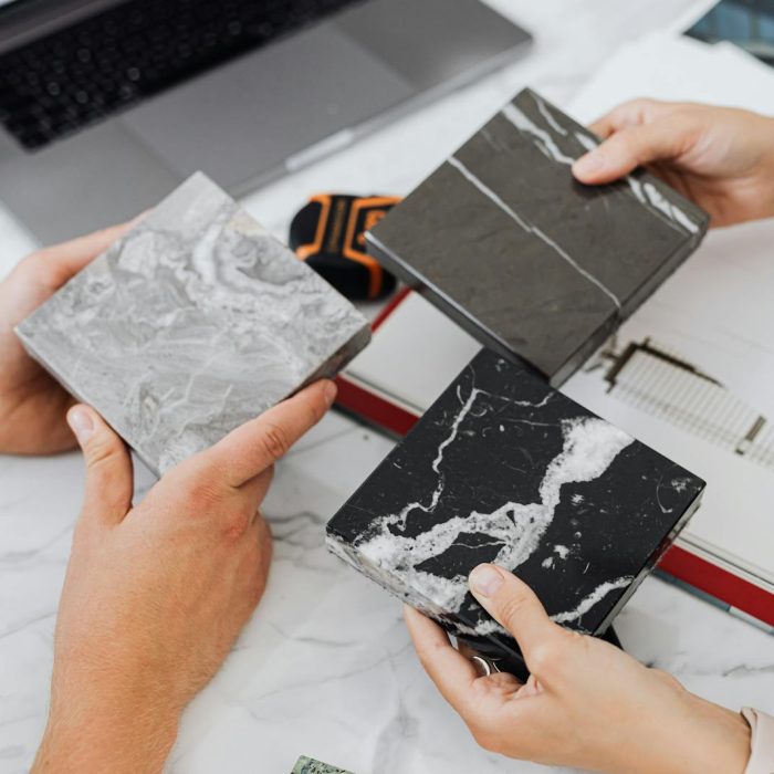 People Holding Tile Samples